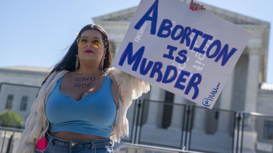 Una manifestante con una pancarta que dice "el aborto es asesinato" en frente del Tribunal Supremo de EEUU, el 6 de junio de 2022. Shawn Thew
