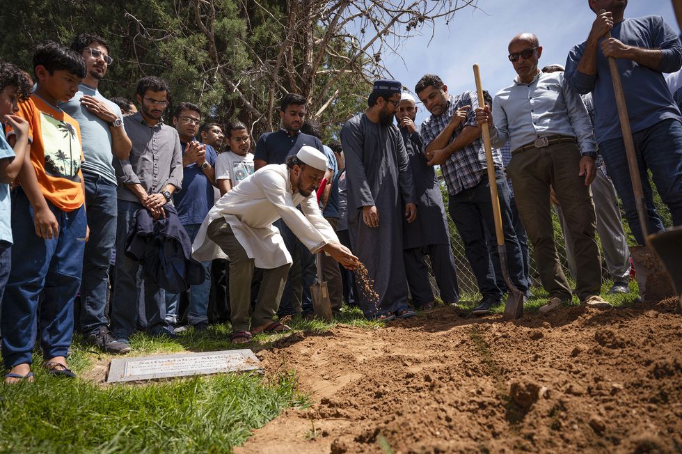 Un hombre echa tierra durante el entierro de Muhammad Afzaal Hussain, la tercera víctima, de 27 años, el pasado 5 de agosto.Chancey Bush