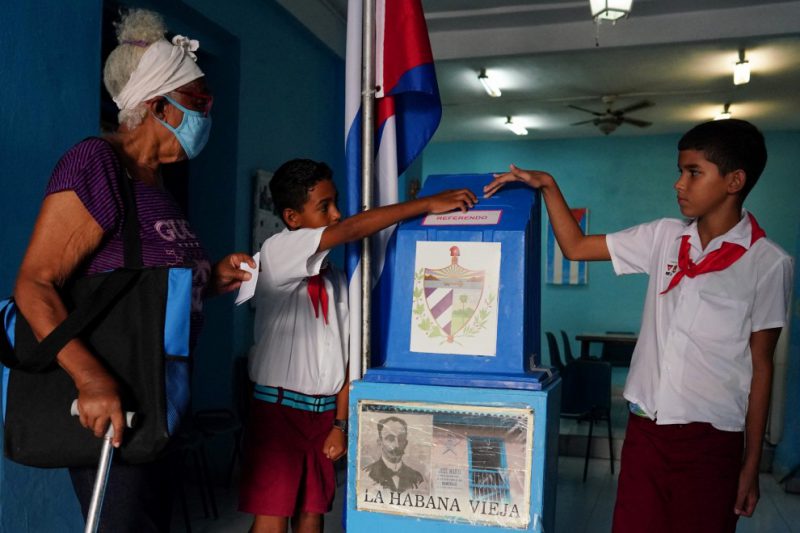 Los niños ayudan a una votante a emitir su voto en un colegio electoral durante el referéndum del nuevo Código de Familia en La Habana, Cuba , el 25 de septiembre de 2022. — Alexandre Meneghini / Reuters