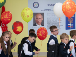 Un grupo de alumnos pasa junto a un cartel con la imagen del presidente ruso, Vladímir Putin, tras la ceremonia de inicio del año escolar 2024-2025 en una escuela de San Petersburgo.Andrei Bok (SOPA Images/LightRocket/Getty)