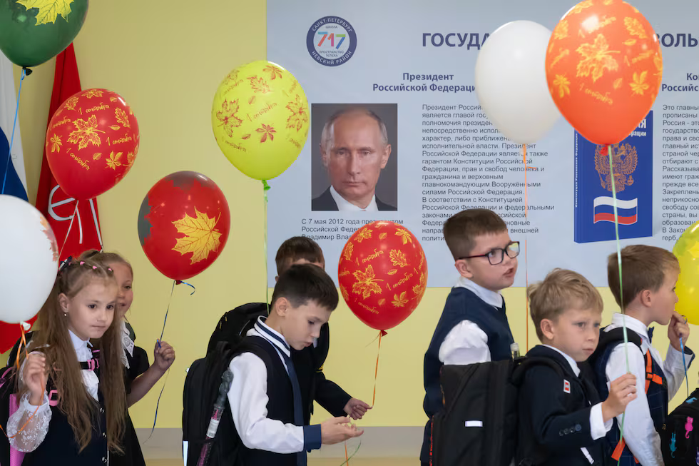 Un grupo de alumnos pasa junto a un cartel con la imagen del presidente ruso, Vladímir Putin, tras la ceremonia de inicio del año escolar 2024-2025 en una escuela de San Petersburgo.Andrei Bok (SOPA Images/LightRocket/Getty)